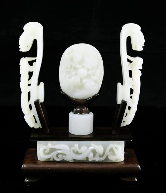 A collection of Chinese archaistic pale celadon jade belt fittings and a white jade archers ring, 17th-19th century,